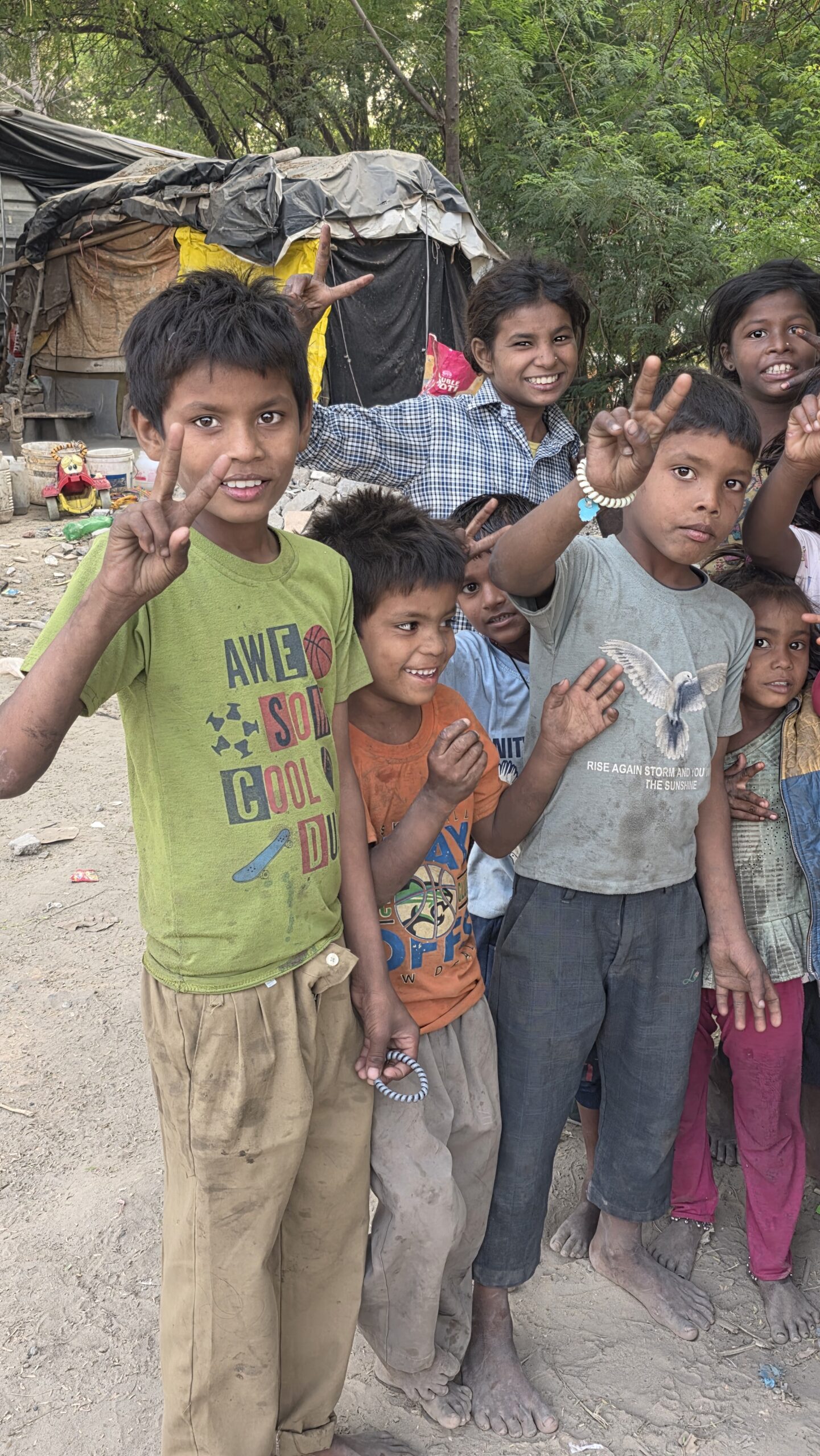 Joyful slum children celebrating a sponsored birthday with custom party caps