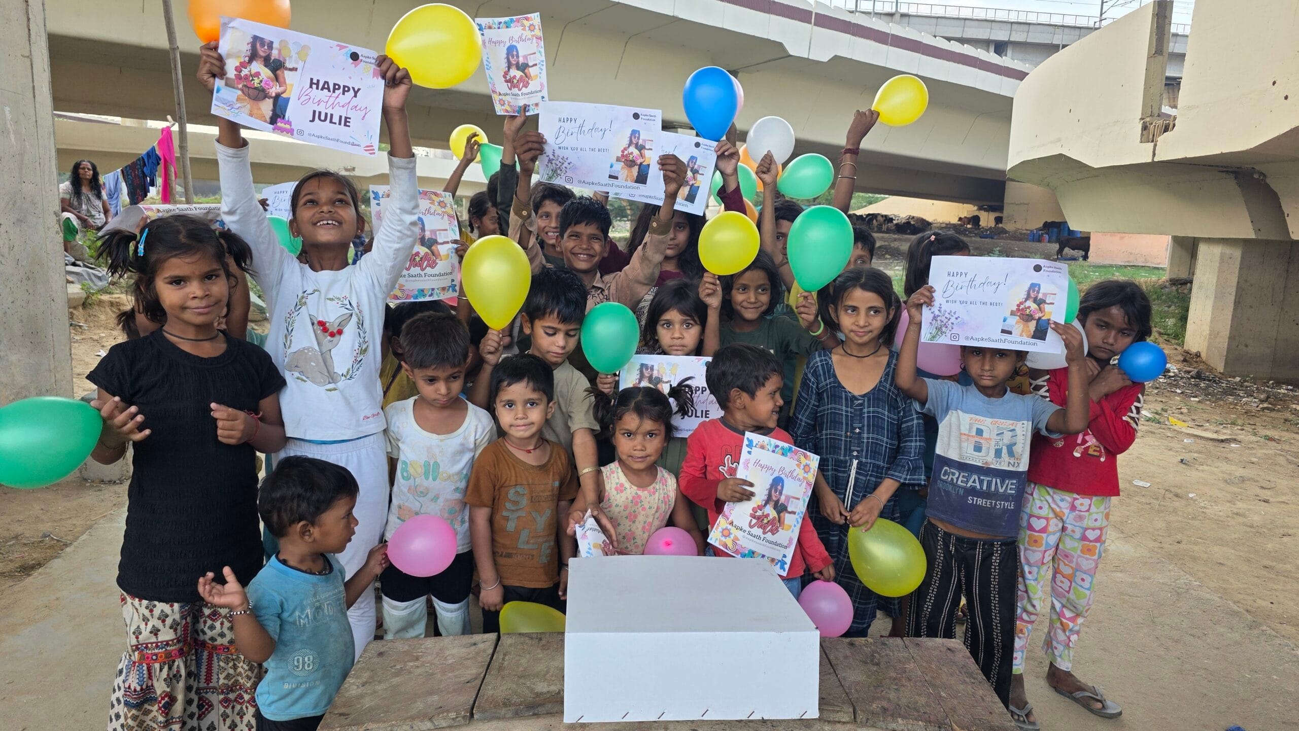 NGO volunteers distributing hot meals and birthday treats to kids in need