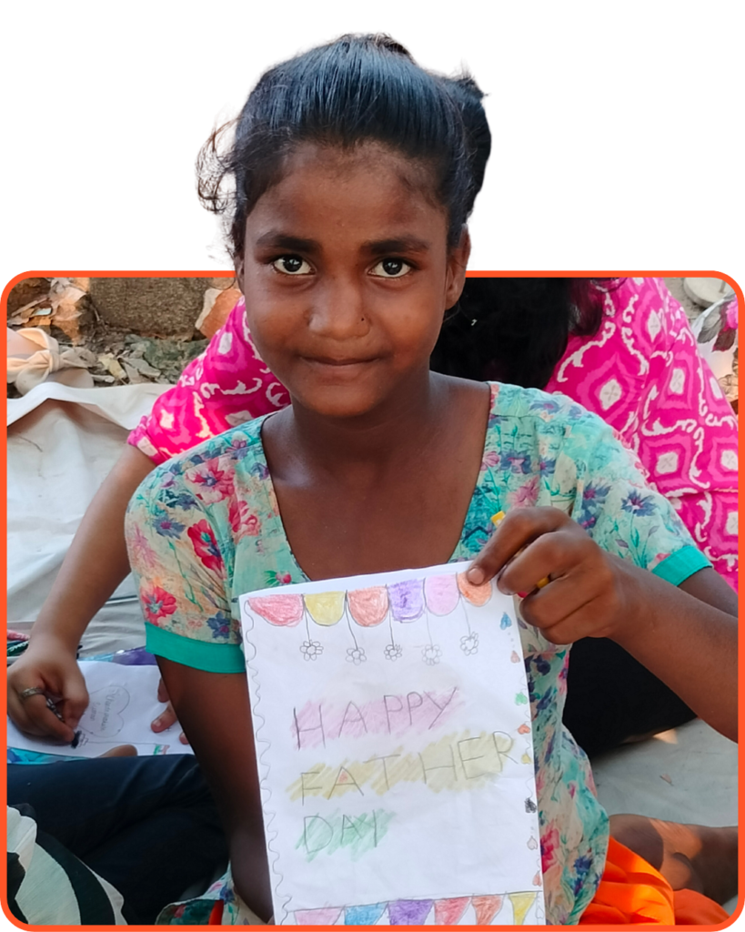 Smiling underprivileged girl in India holding a handmade greeting card, showcasing the creative learning made possible through education donations.