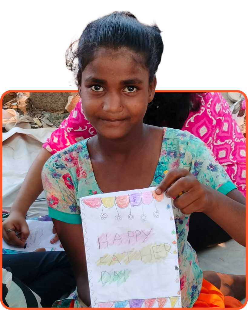 BirthdayDonate.org 14 Smiling underprivileged girl in India holding a handmade greeting card, showcasing the creative learning made possible through education donations.